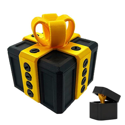 Black gift box with yellow ribbon and bow, and small black ring box with gold ring inside